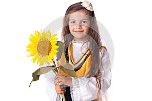 Girl in traditional Bulgarian folklore costume and sunflower. Kid portrait