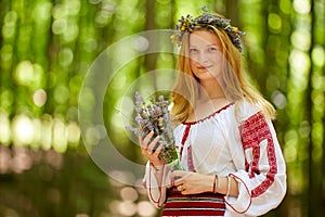 Girl in traditional costume in the forest