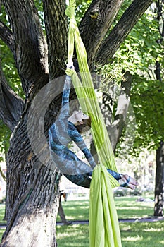 Girl training on silks on open air