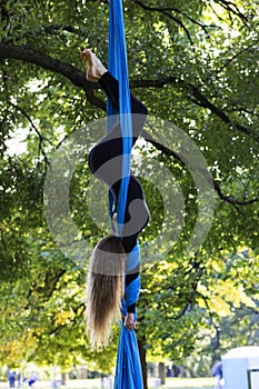 Girl training on silks on open air