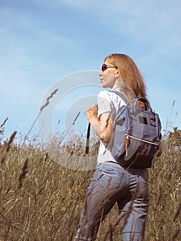 Girl Traveler hiking with backpack at Alpine meadows. Travel Lifestyle concept adventure summer vacations outdoor.