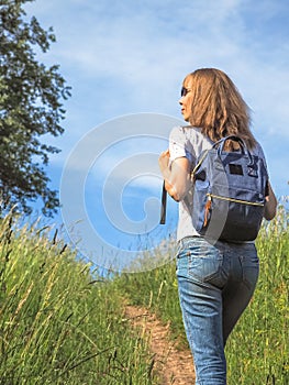 Girl Traveler hiking with backpack at Alpine meadows. Travel Lifestyle concept adventure summer vacations outdoor.