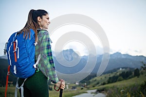 Girl traveler hiking with backpack at rocky mountains landscape. Travel lifestyle concept adventure