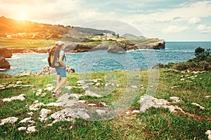 Girl traveler looks on beautiful sea landscape