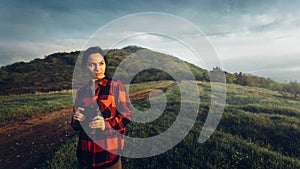 Girl Traveler In Red Plaid Shirt With Binoculars In Hands Looks Into Distance On Landscape Background. Scout Travel Adventure Conc