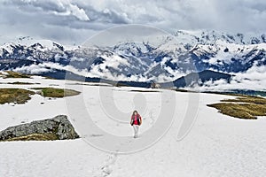 A girl traveler walks uphill.