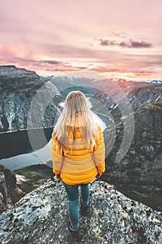 Girl traveling alone enjoying sunset mountains