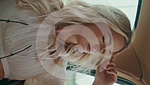 Girl travelling car backseat looking window close up. Woman riding auto vertical