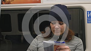 Girl travelling in subway and looking in paper map