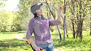 Girl treasure hunter with metal detector finds treasure and takes it from the ground