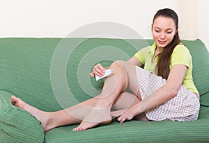 Girl treating feet with ointment