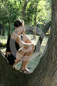 Girl on the tree in park