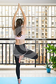 Girl in Tree yoga pose at home