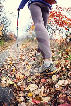 A girl with trekking sticks.