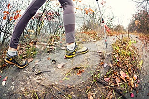 A girl with trekking sticks.