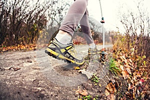 A girl with trekking sticks.