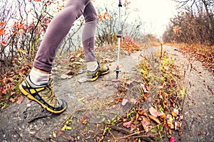 A girl with trekking sticks.