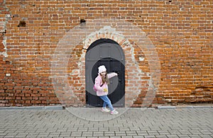 A girl tries to open the door of a medieval fortress