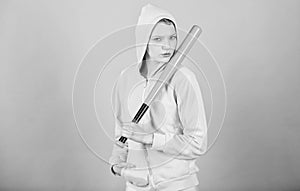 Girl troublemaker. Woman play baseball game or going to beat someone. Girl hooded jacket hold baseball bat blue