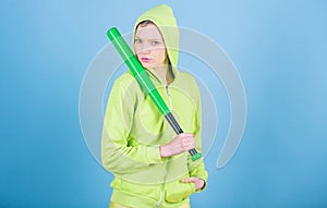 Girl troublemaker. Woman play baseball game or going to beat someone. Girl hooded jacket hold baseball bat blue photo