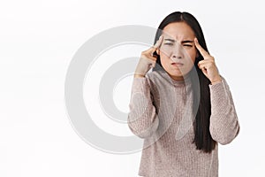 Girl trying destroy with power of thought, squinting and looking pissed, outraged, curse rival in mind, touching temples