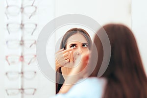 Girl Trying on Medical Contact Lenses in the Mirror