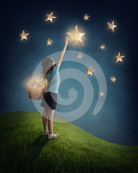 Girl trying to catch a star photo