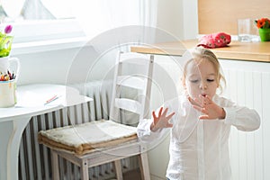 Girl trying to dry her freshly painted finger nails