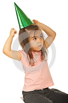 Girl trying to put party hat