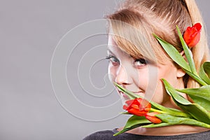 Girl with tulip feel connection to nature.