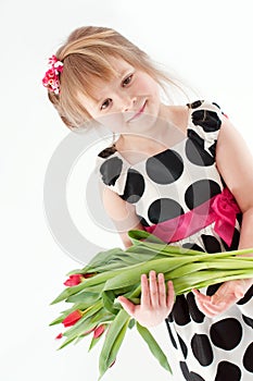 A girl with tulips over light background