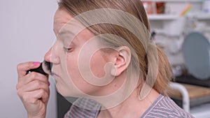 Girl twists her index finger at temple showing madness