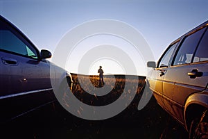 Girl between two cars