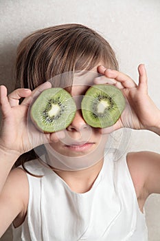 Girl with two Kiwis on the eyes