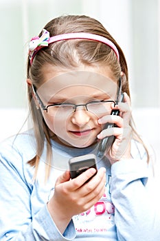 Girl with two mobile phones