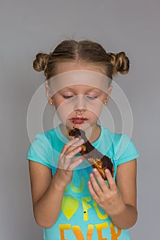 The girl with two plaits biting a chocolate cake