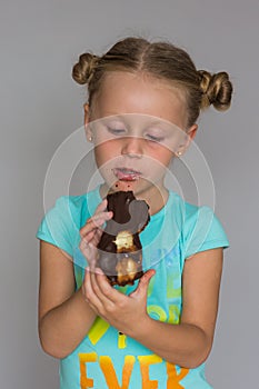 The girl with two plaits biting a chocolate cake