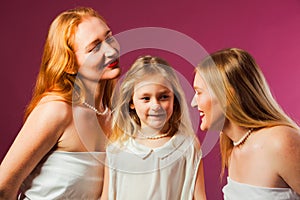 Girl with two women, all wearing white