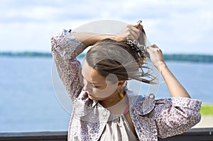 Girl tying her hair hairpins