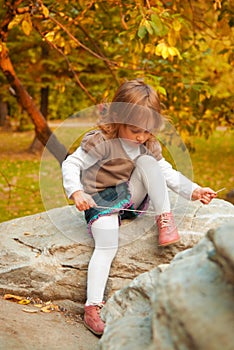 Girl tying shoelace