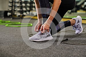 Girl tying shoelace on her sport shoes