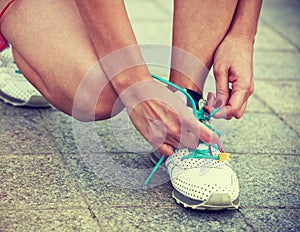 Girl tying shoes laces