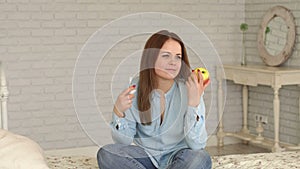 A girl with type 1 diabetes at home with insulin and apple in her hands.