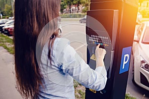 Girl types the text with her hands for making out the ticket for parking machine parking and payment for travel