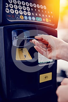 Girl types the text with her hands for making out the ticket for parking machine parking and payment for travel