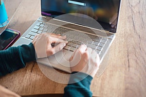 Girl typing on laptop and relaxing