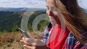 Girl typing message on mobile phone. Woman scrolling touchscreen on cellphone