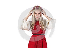 Girl in Ukrainian costume holding her flower chaplet