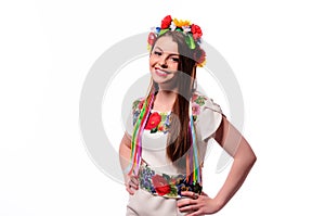 Girl in Ukrainian national traditional costume holding her flower chaplet - isolated on white