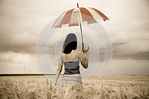 Girl with umbrella at field